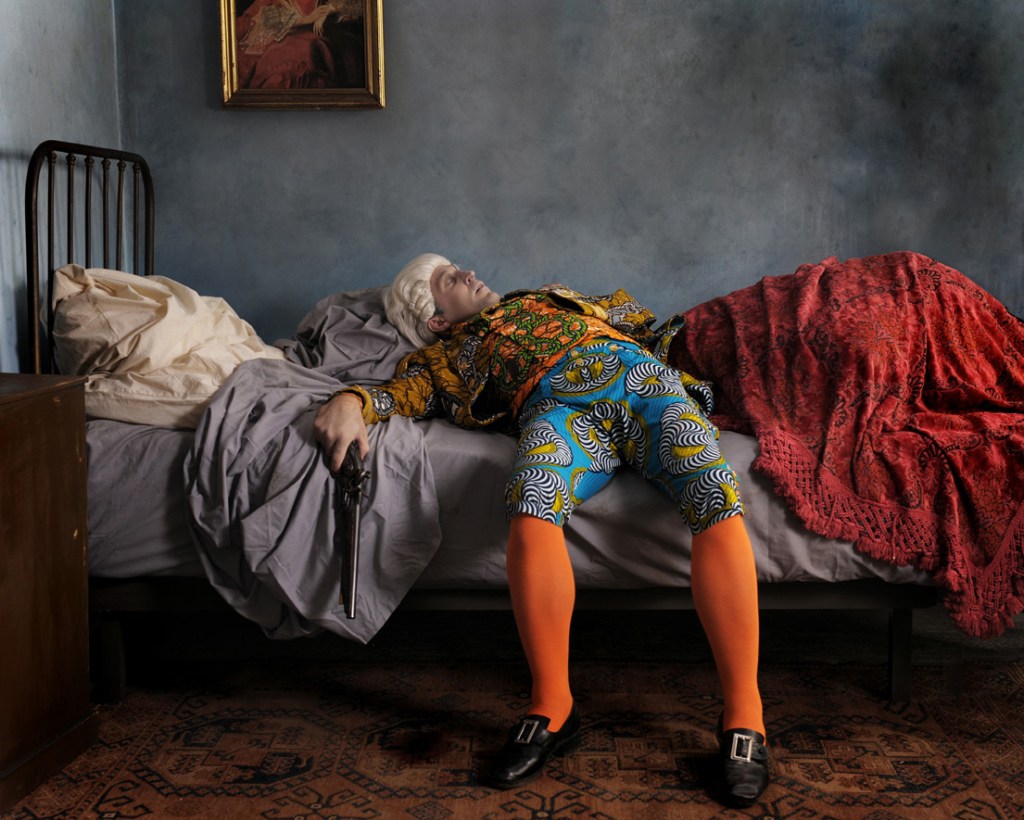 ake Death Picture, Yinka Shonibare MBE. One of the digital paintings on display. The outfit Nelson is wearing is a replica of his Trafalgar uniform minus the bullet hole