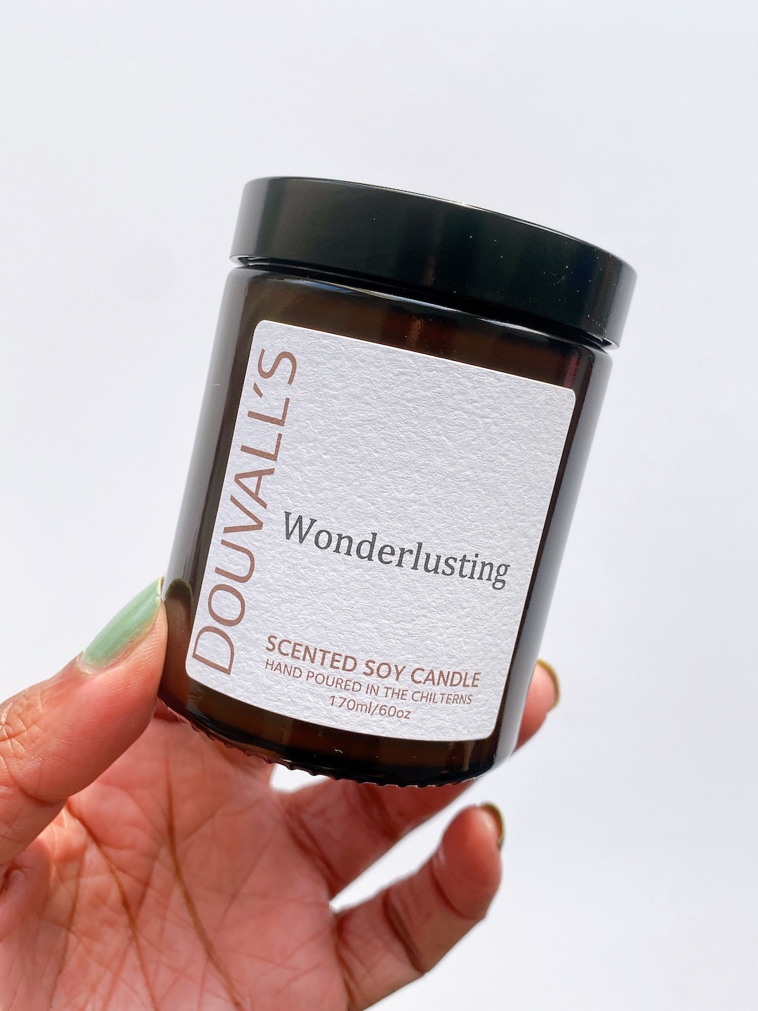 hand holding Douvall's eco candle sustainable gift idea