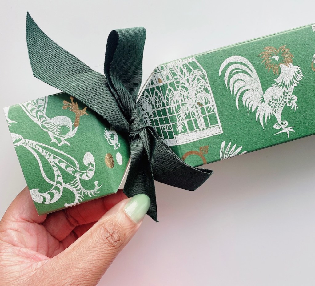 hand holding ribbon on christmas cracker illustra